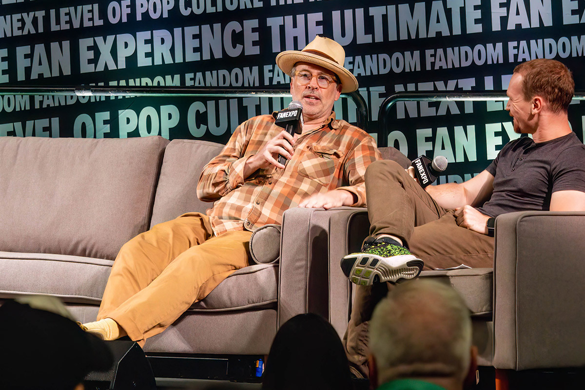 Jason Lee speaks on stage while sitting down