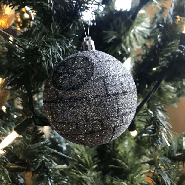 A round ornament with a Death Star design on it