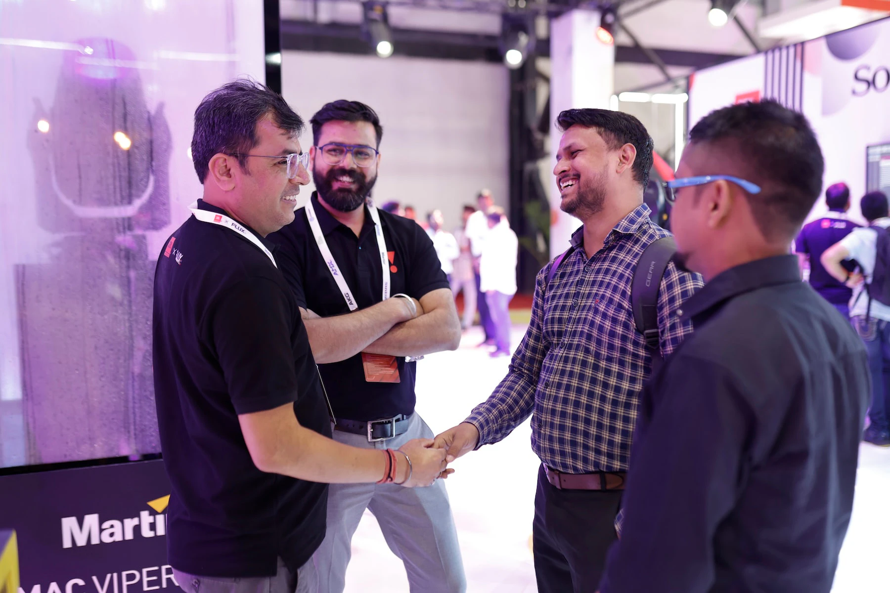 Four attendees shaking hands at the Palm event