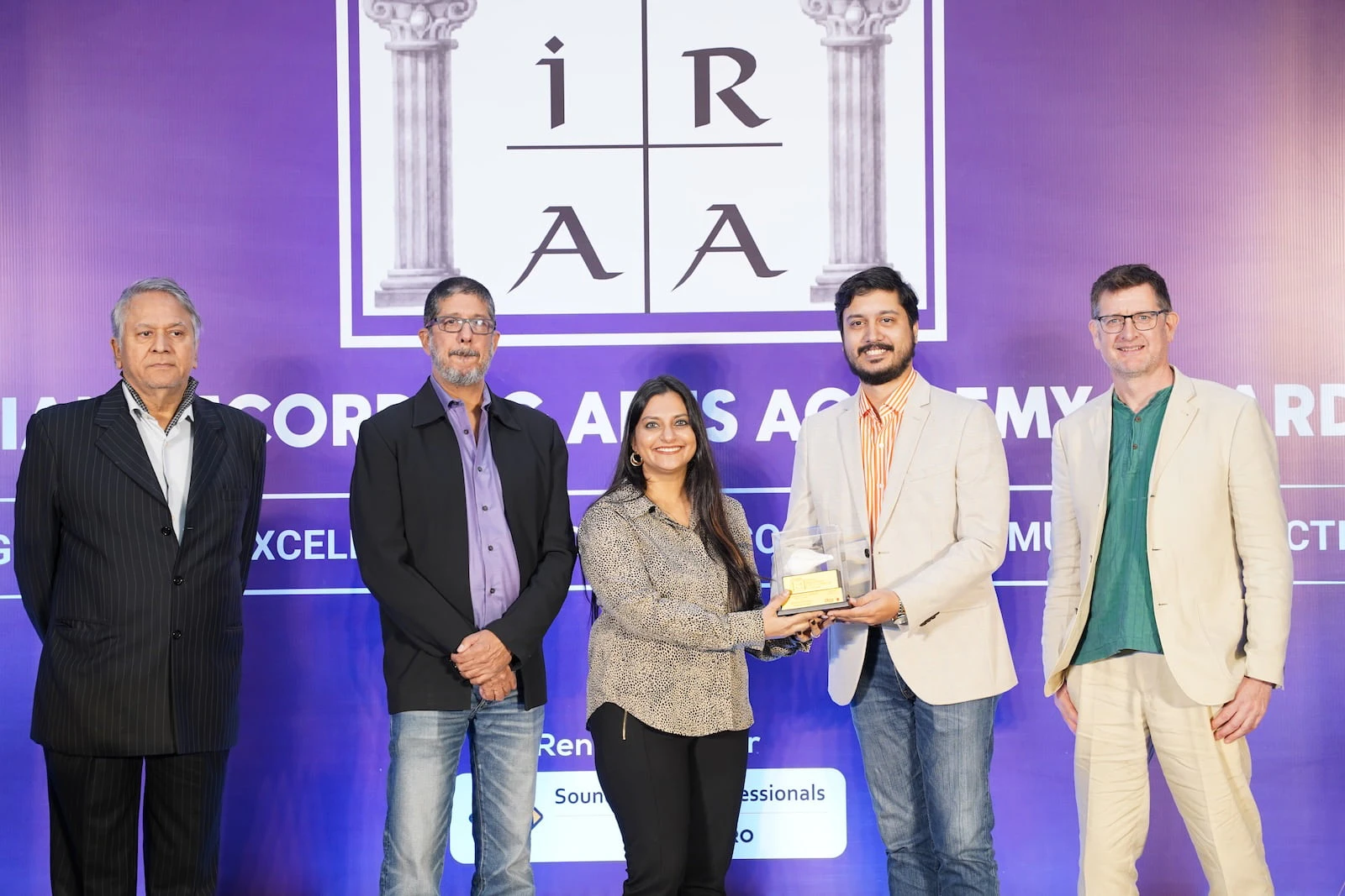Group of award winners posing with trophies at the IRAA Awards