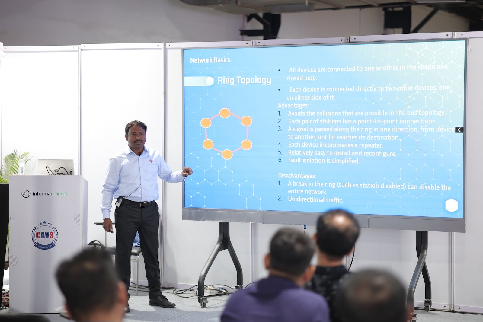 Instructor delivering a technical AV lecture with a visual presentation at PALM Expo