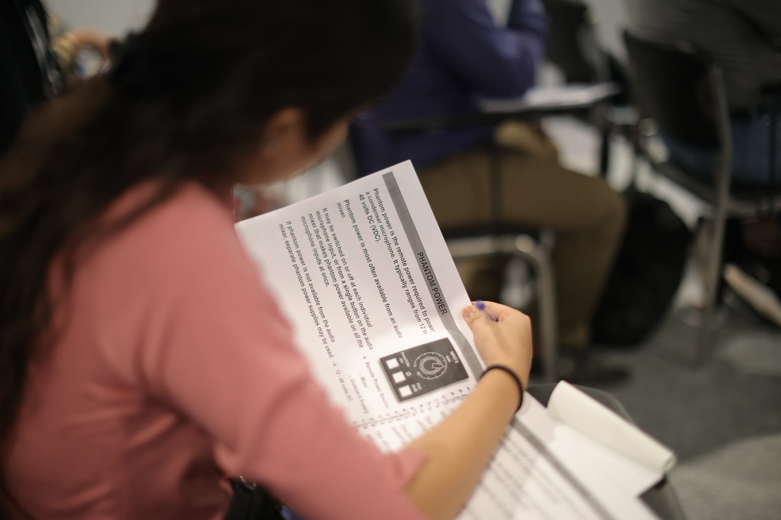Close-up of attendee interacting with course materials during AV training session