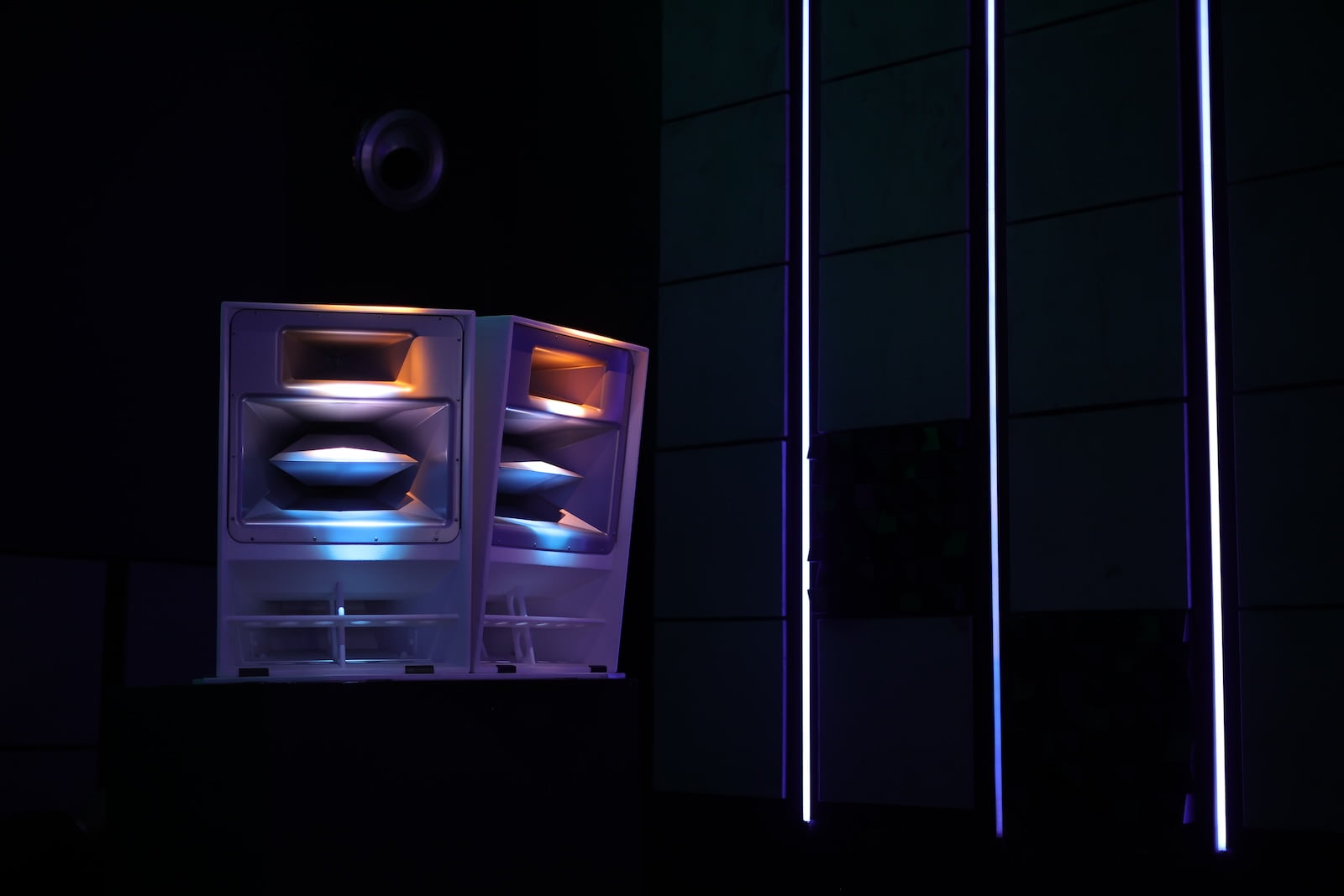 Illuminated professional loudspeakers with colorful lighting effects inside Demo Qube at PALM Expo