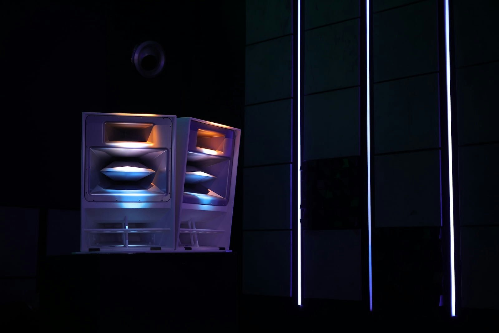 Illuminated professional loudspeakers with colorful lighting effects inside Demo Qube at PALM Expo