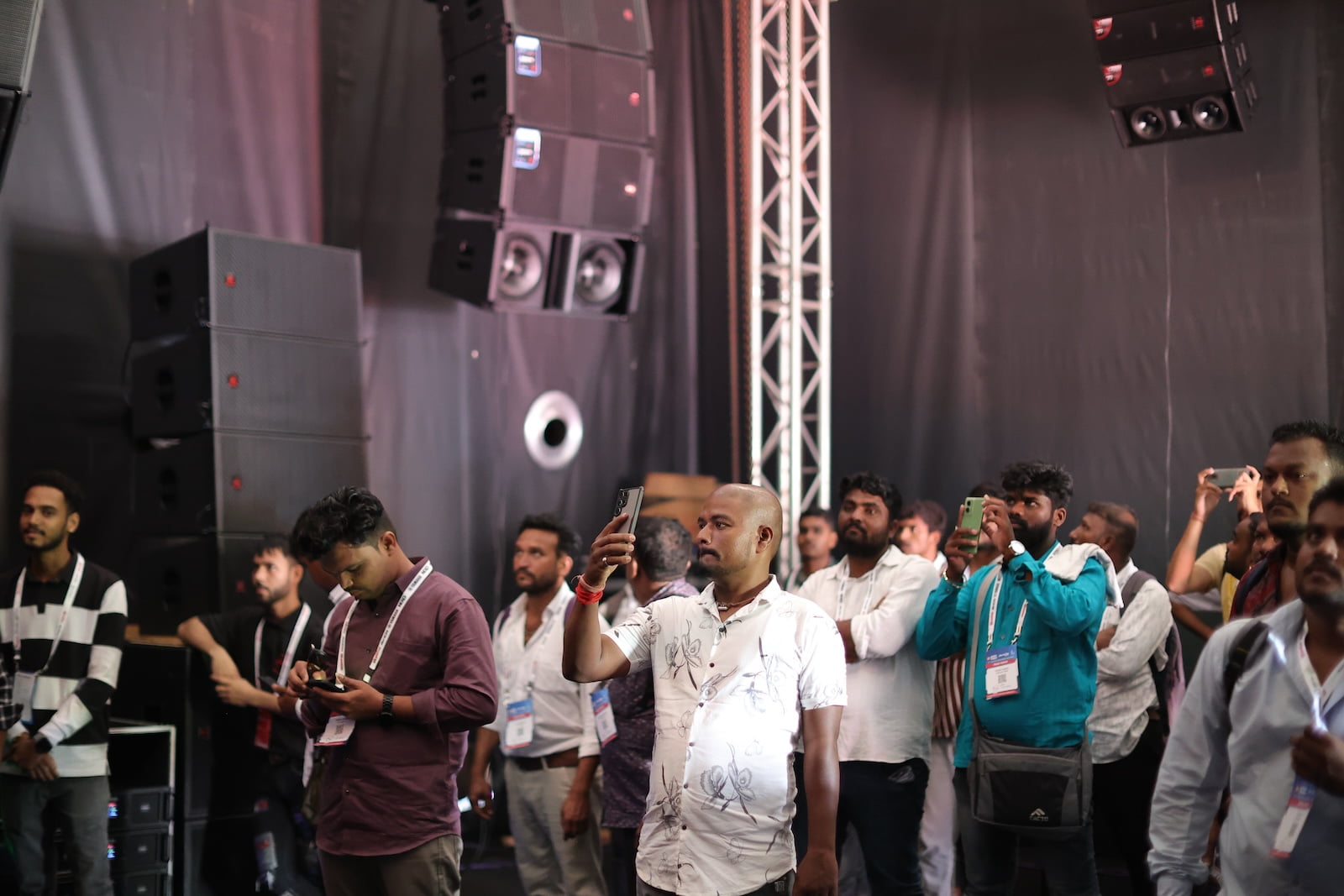 Visitors observing professional audio equipment demonstrations inside Demo Qube at PALM Expo