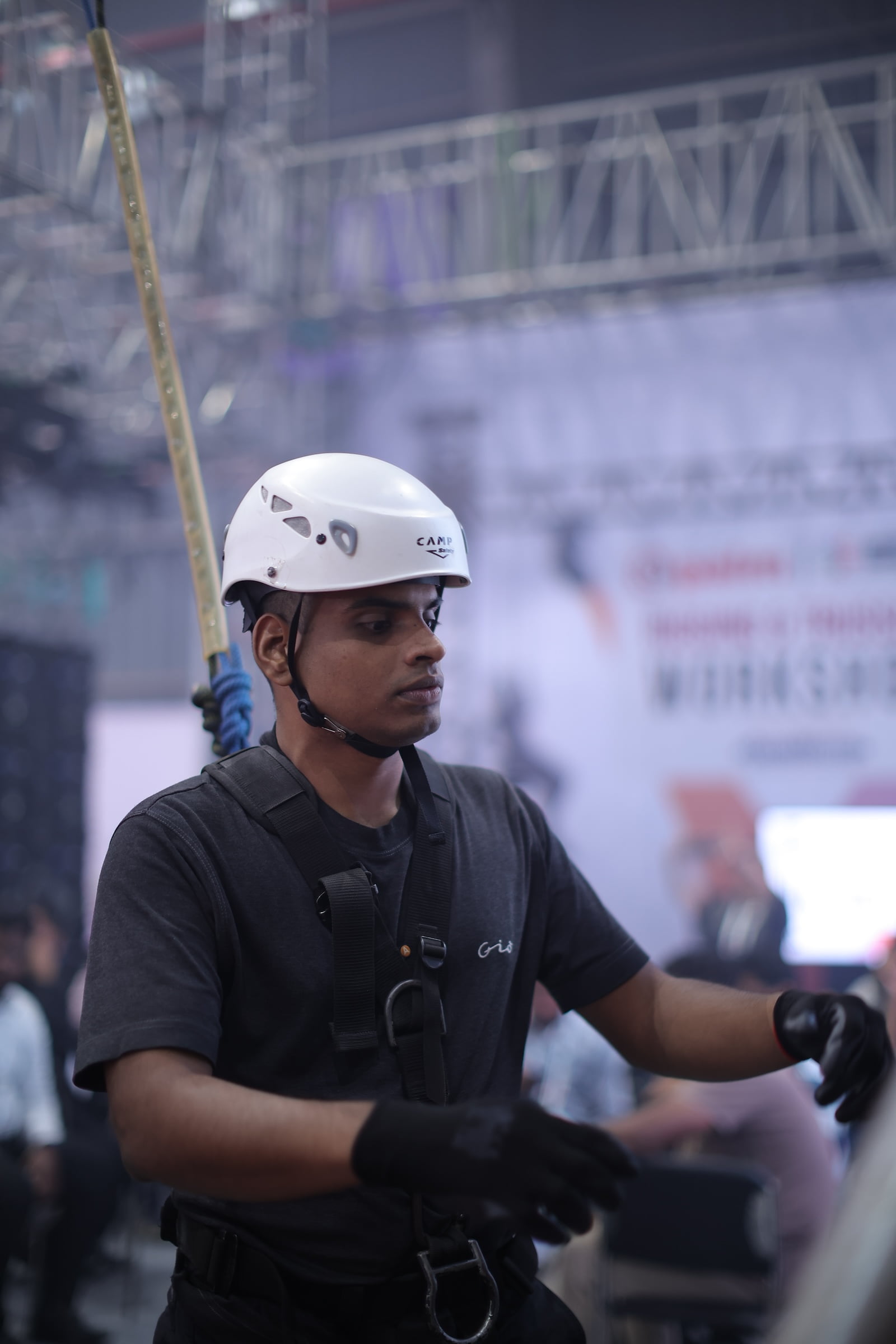 Workshop participant wearing safety gear during live rigging demonstration at PALM Expo