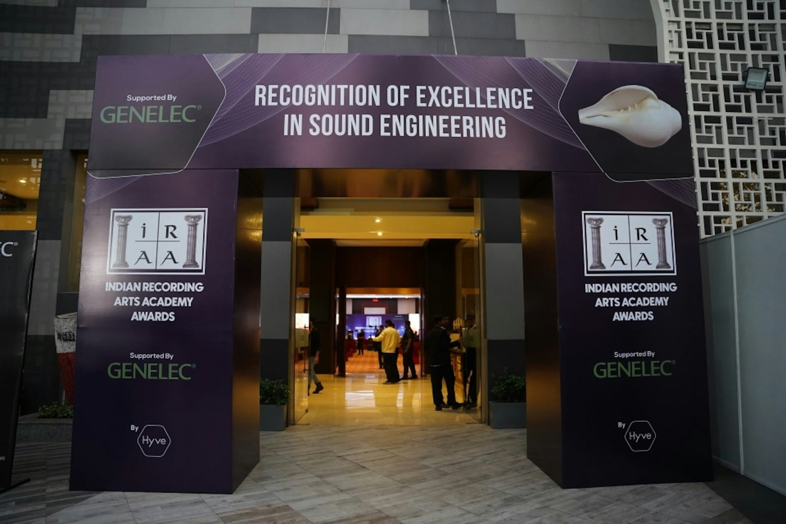 Indian Recording Arts Academy Awards ceremony at PALM Expo with branded backdrop and award presentation.