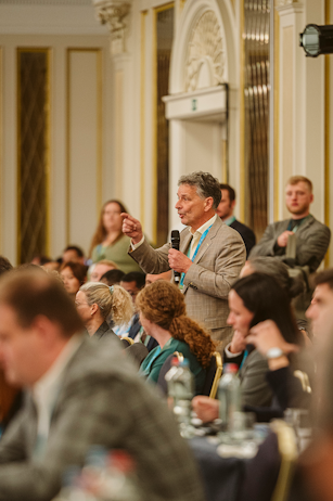 Speaker presenting on stage at World Ethanol & Biofuels 2025 in Brussels, addressing delegates on global ethanol policy.