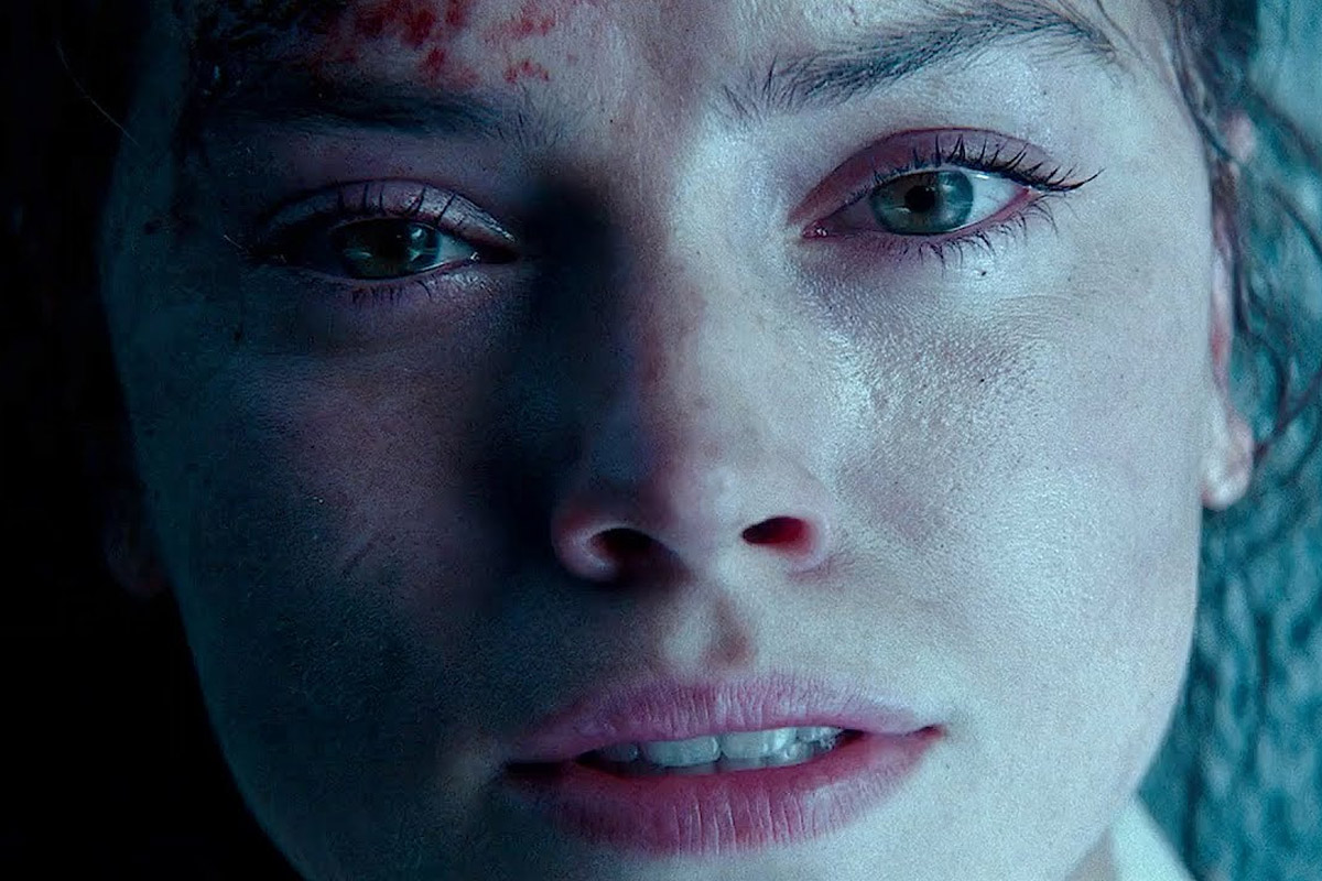 Rey Skywalker stares upwards while laying on the ground