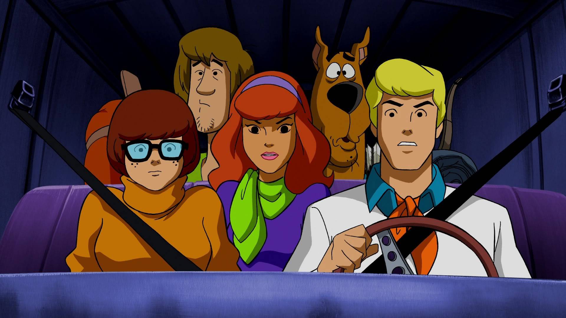 The Scooby Doo gang crowded in and strapped in to the Mystery Machine as Fred drives