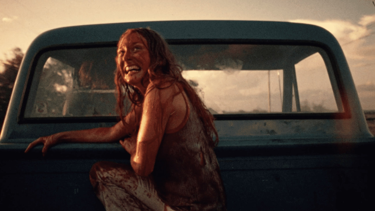 Golden hour hits, as Sally, sat, covered in blood, in the bed of a blue pick up truck, laughs triumphant and tearfully. They ride away from the movie's antagonist, Leatherface, Sally is covered in blood and full of relief.