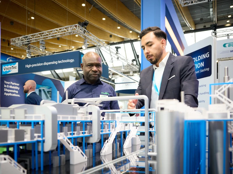 An exhibitor showing his product to an attendee