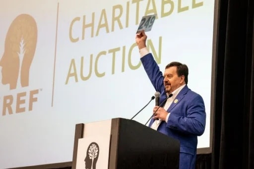 EREF Charitable Auction presenter onstage