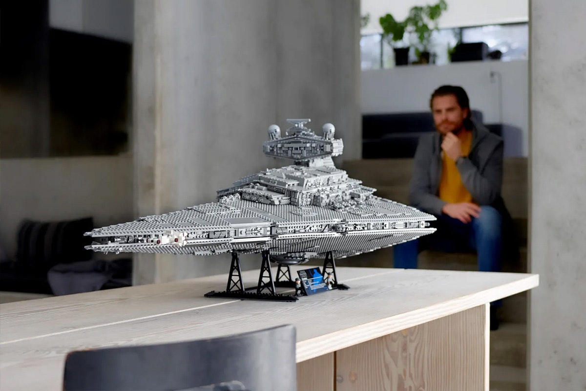 Star Wars Star Destroyer on a black stand with two little empire military officer figurines underneath.
