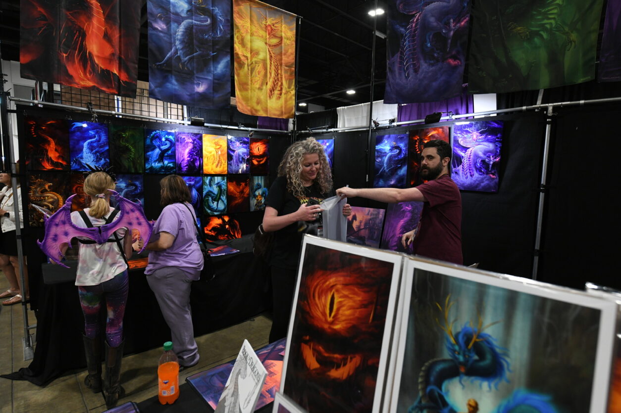 Fans browse and purchase a selection of dragon art and gifts