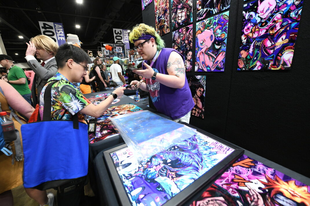 Fan purchasing a neon print from our sponsor V1 tech