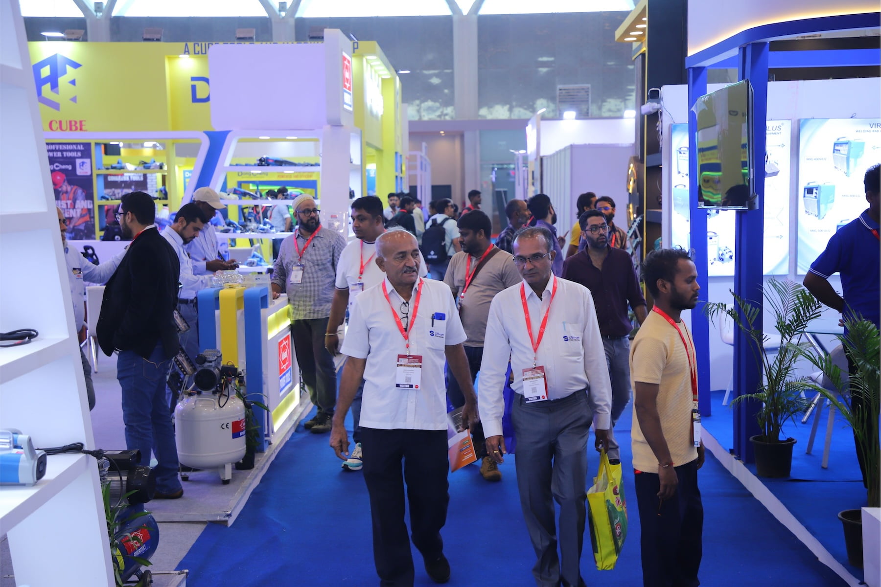 Industrial professionals touring exhibition aisles at Tools & Equipment Expo, Yashobhoomi New Delhi.