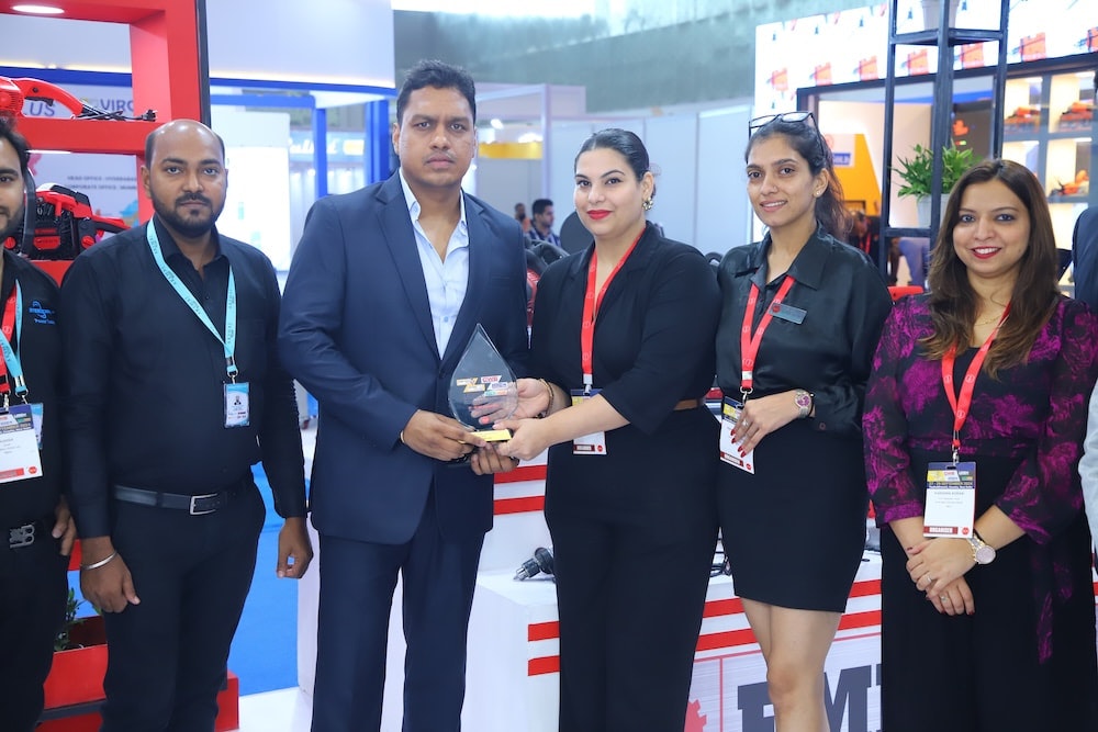 Exhibitor receives an Excellence Award from show representatives on the trade floor.