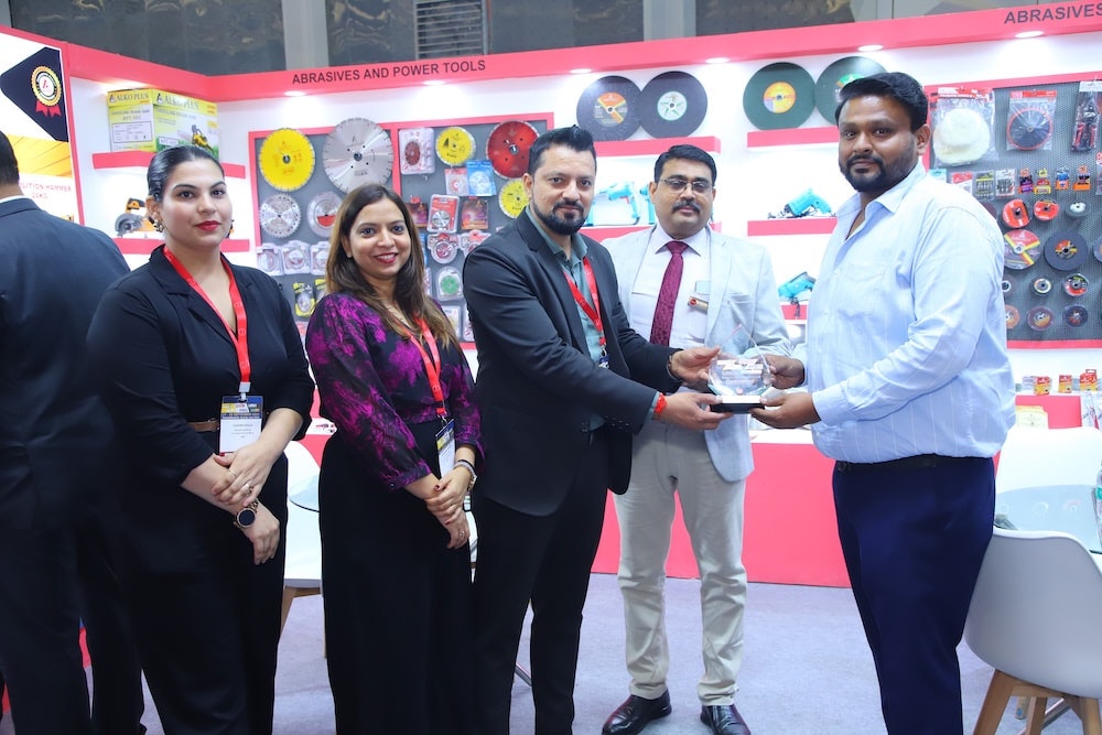 Exhibitor accepts an Excellence Award in the abrasives and power tools pavilion.