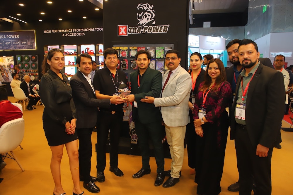 Xtra Power booth hosts an Excellence Award presentation with the team.