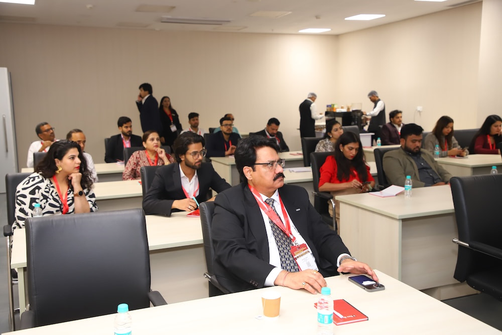 Attendees seated in a conference room taking notes during the networking program.