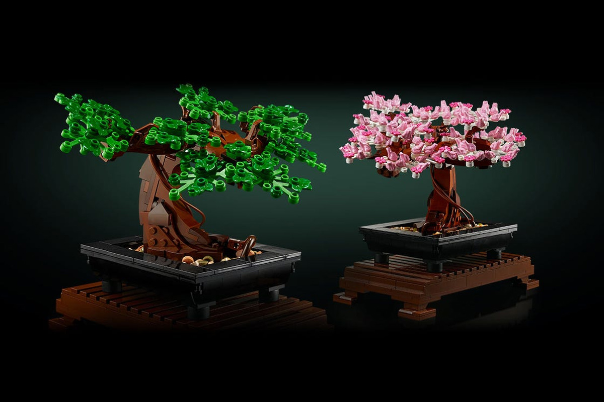 Lego Bonsai Tree with the pink flowers on. Beside it is a Lego Bonsai Tree with green leaves.