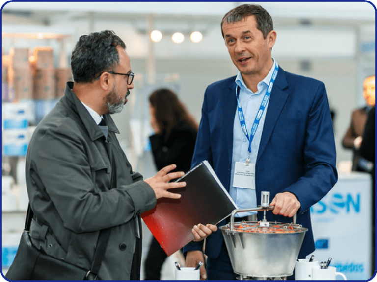 Exhibitor talking to visitors at Tissue World