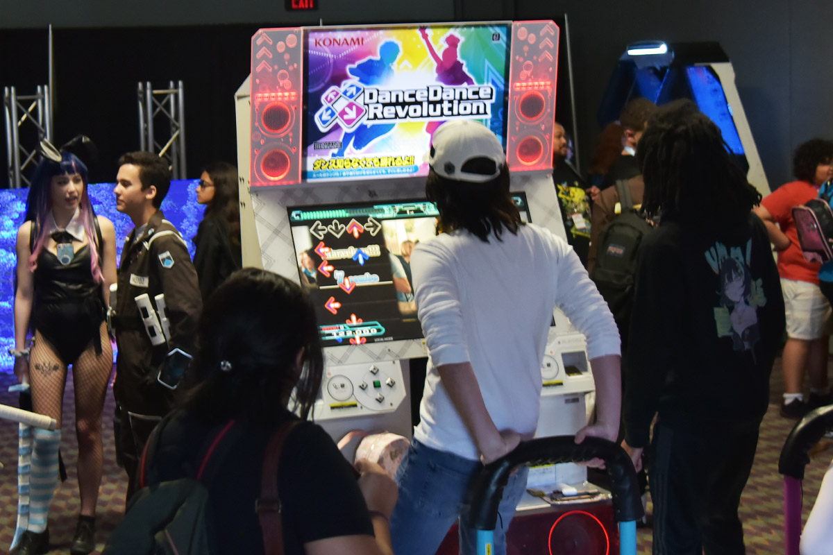 A fan plays Dance Dance Revolution