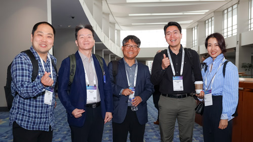 Data Center World attendees smiling at camera