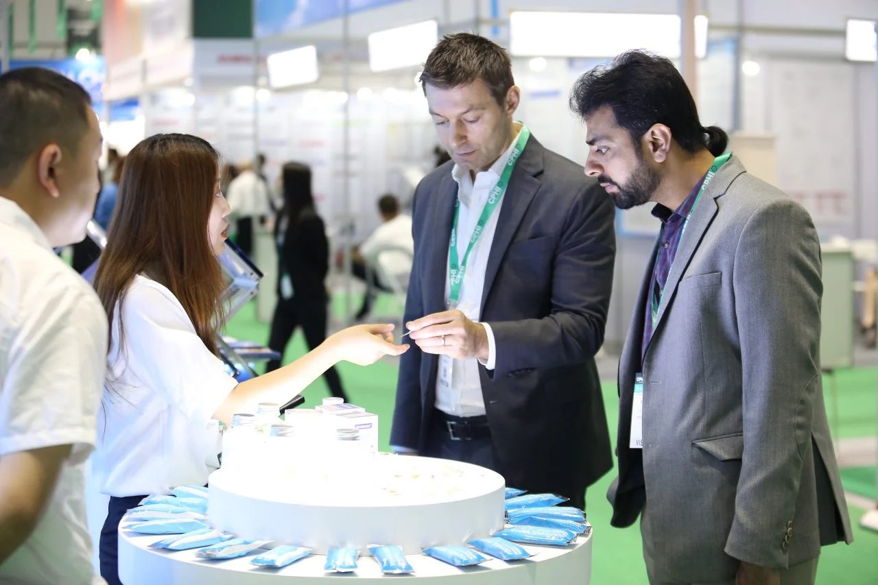 Pharma professional showcasing product to buyer at CPHI SEA