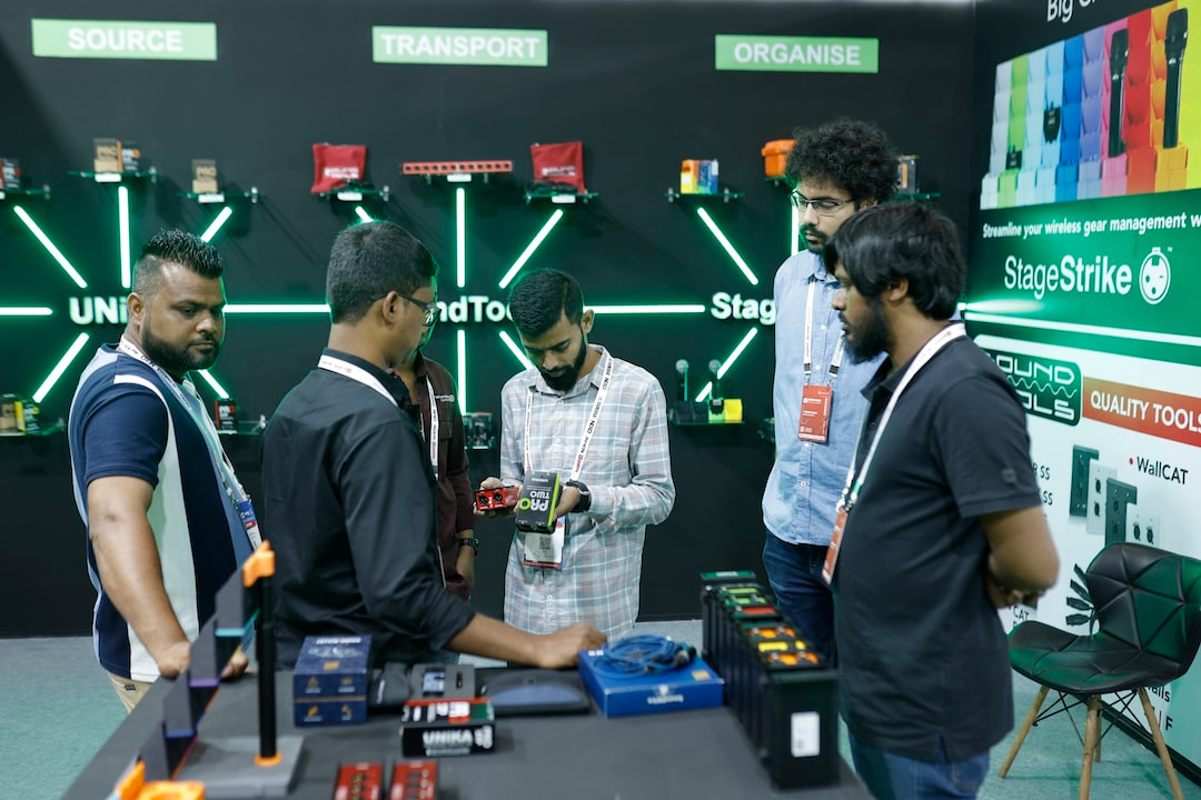 Several attendees exploring the products at a booth while exhibitors demonstrate solutions and engage with their questions