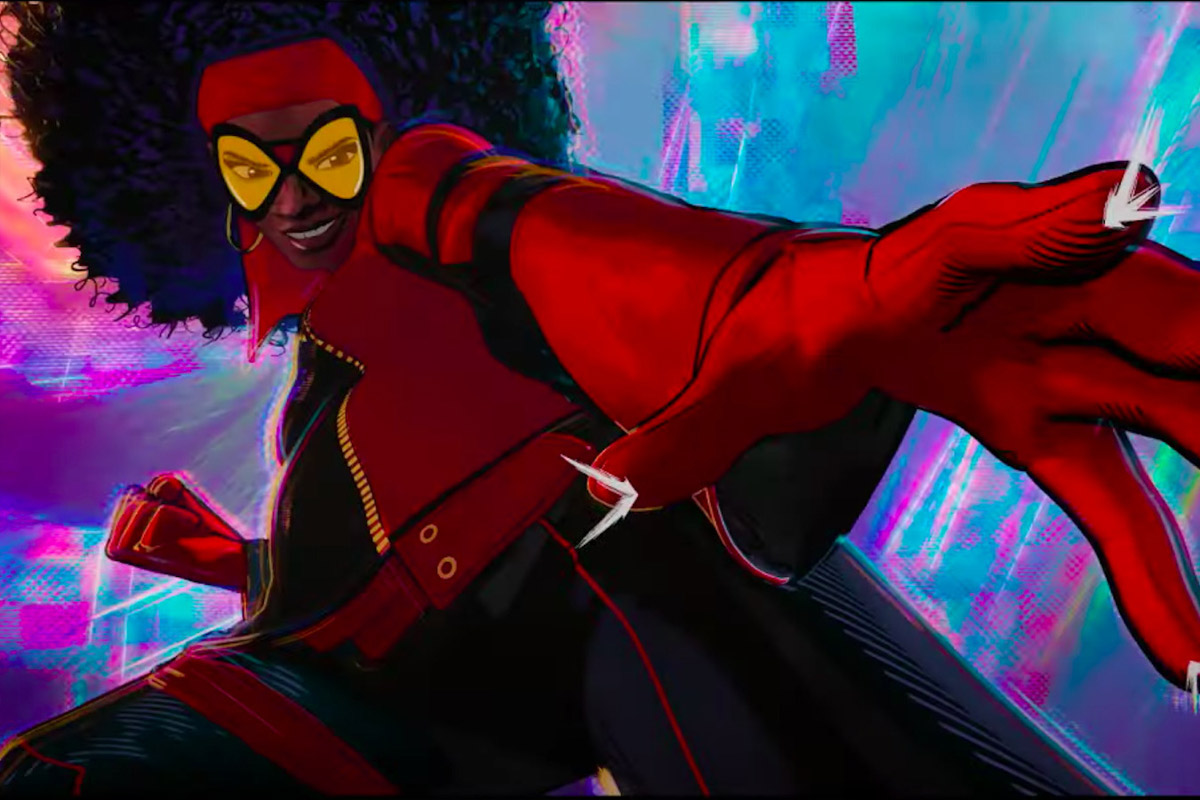 Spider Woman stands confidently with her hand outstretched