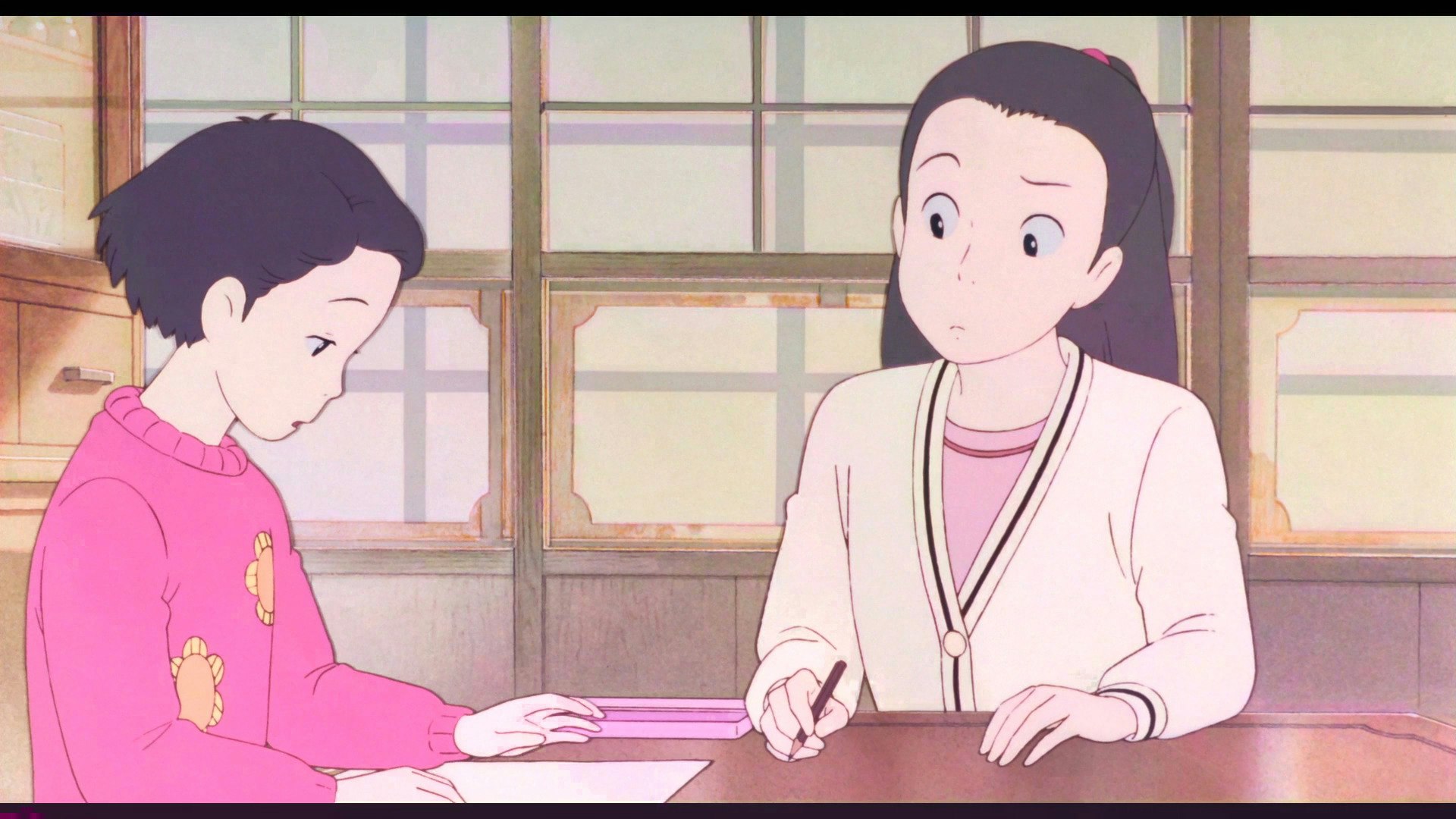 Two characters sit at a table looking at a blank piece of paper